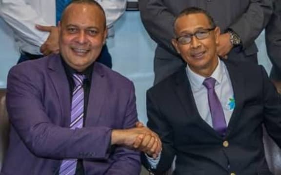 Sam Basil (left) hands over to Ian Ling-Stuckey.