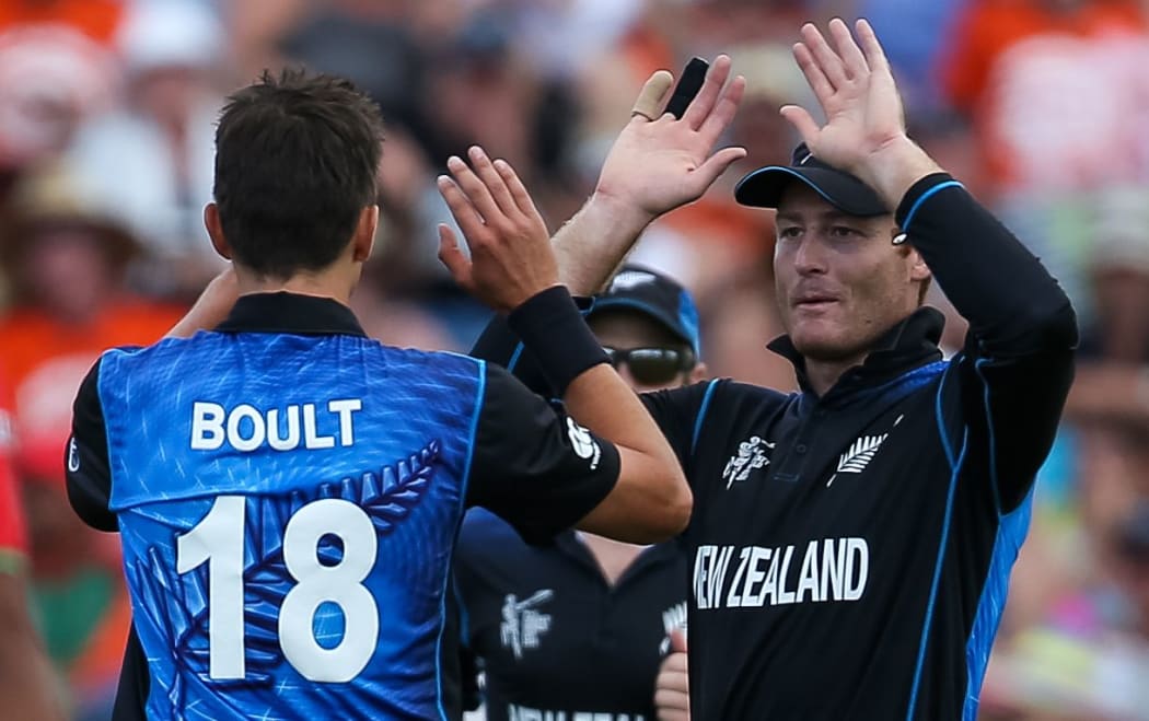 Trent Boult and Martin Guptill celebrate the dismissal of Bangladesh batsman Imrul Kayes.