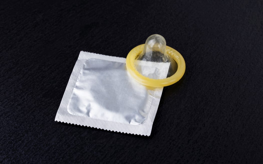 condom and pack on a black background