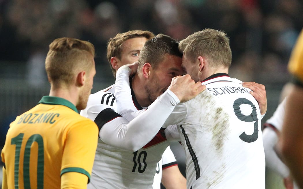 Germany's midfielder Lukas Podolski (L) celebrates scoring the equalising goal with midfielder Andre Schuerrle.