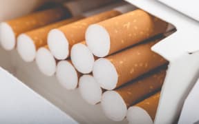 Side view of a pack of cigarettes with faded filter