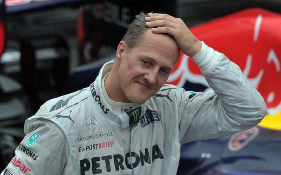 German Formula One driver Michael Schumacher gestures at the end of the Brazil's F-1 GP on November 25, 2012 at the Interlagos racetrack in Sao Paulo, Brazil.  AFP  PHOTO/YASUYOSHI CHIBA (Photo by YASUYOSHI CHIBA / AFP)