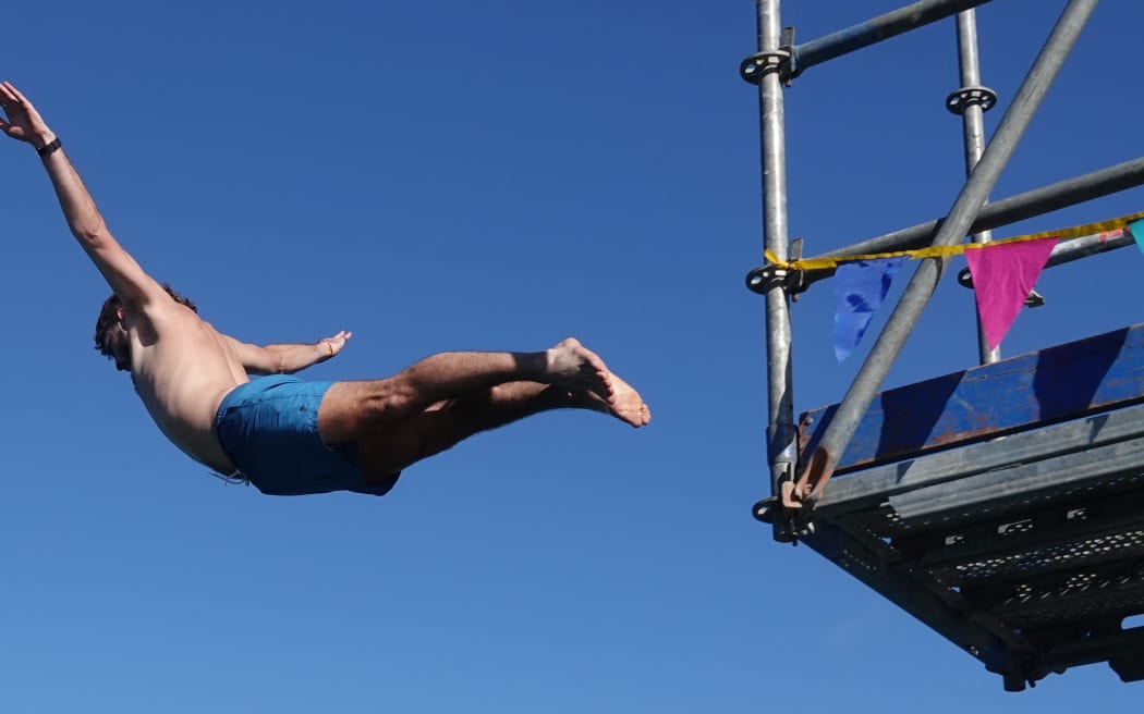 Quinn, from Russell, demonstrates the flying squirrel.
