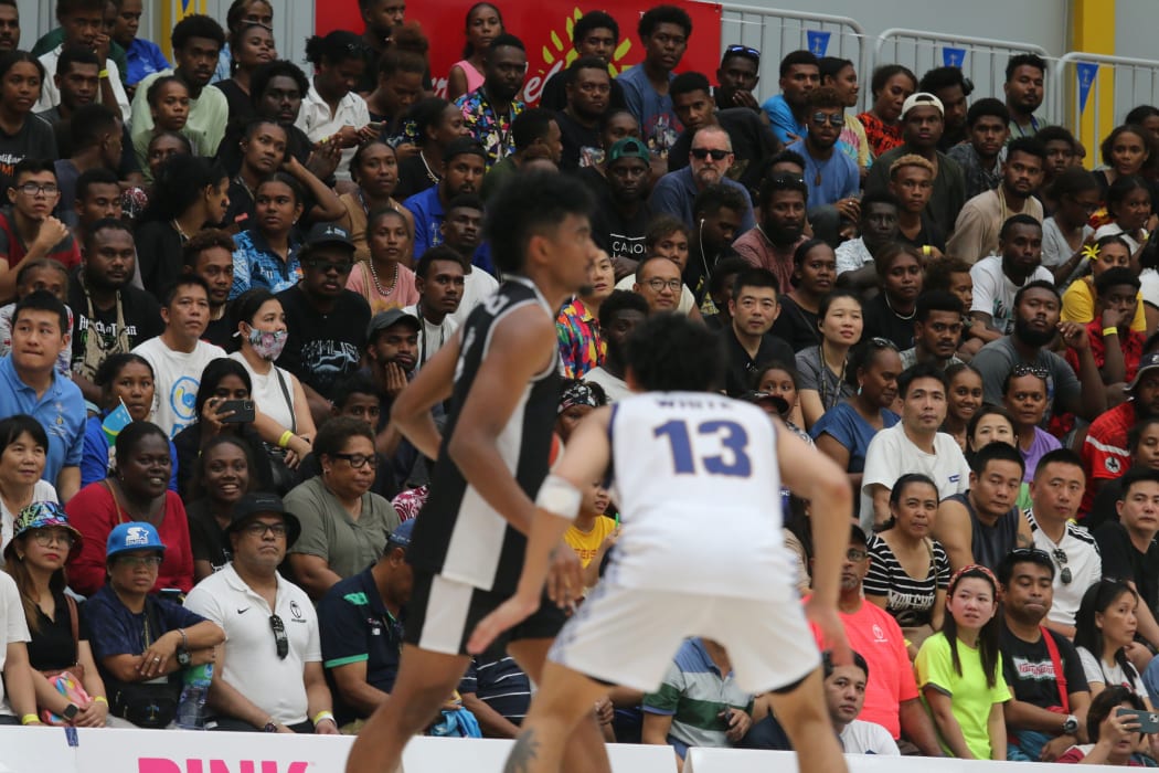 Fans packed into Friendship Hall for the Pacific Games men's basketball final in Honiara between Fiji (dark kit) and Guam.25 November 2023