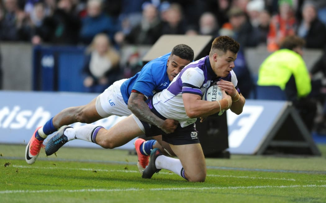 Scotland centre Huw Jones beats the tackle of Samoa centre Reynold Lee-lo.