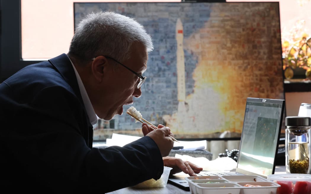 A businessman eating after a meeting, in Beijing, China, 24 April, 2025.