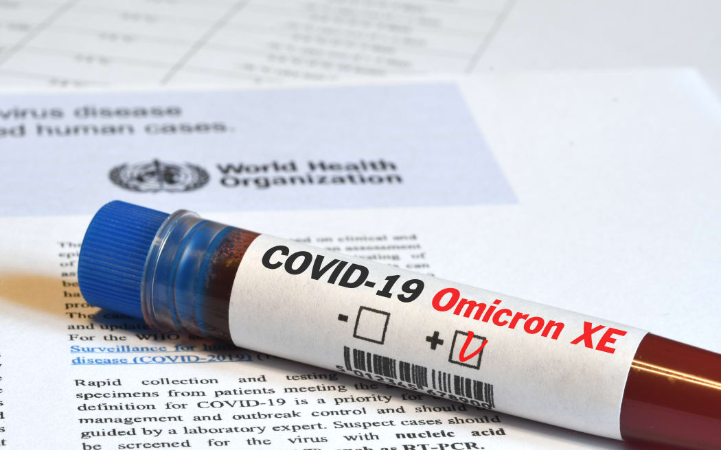 Blood tube for test detection of virus Covid-19 Omicron XE Variant with positive result on papers document.