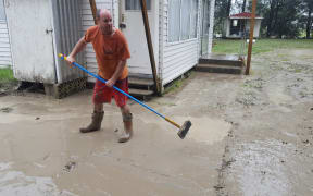 Eskdale Holiday Park campground owner Daniel Gale begins cleaning up after the flooding.