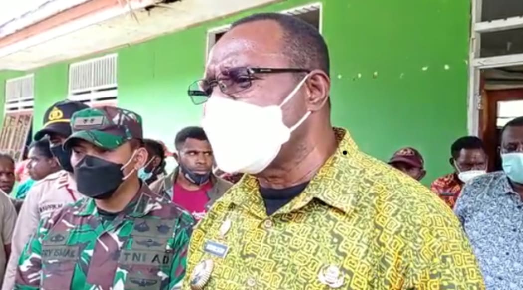 The Bupati of West Papua's Maybrat Regency, Bernard Sagrim, alongside Indonesian military discussing logistical support to displaced people in the region.