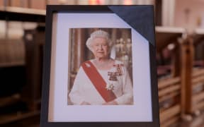 People fill out messages of condolences in a book at St Paul's Church Auckland after the death of Queen Elizabeth II, on 9 September, 2022.