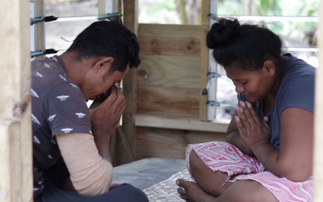 Paulo and Fa'osa pray for their three children who died after contracting measles.