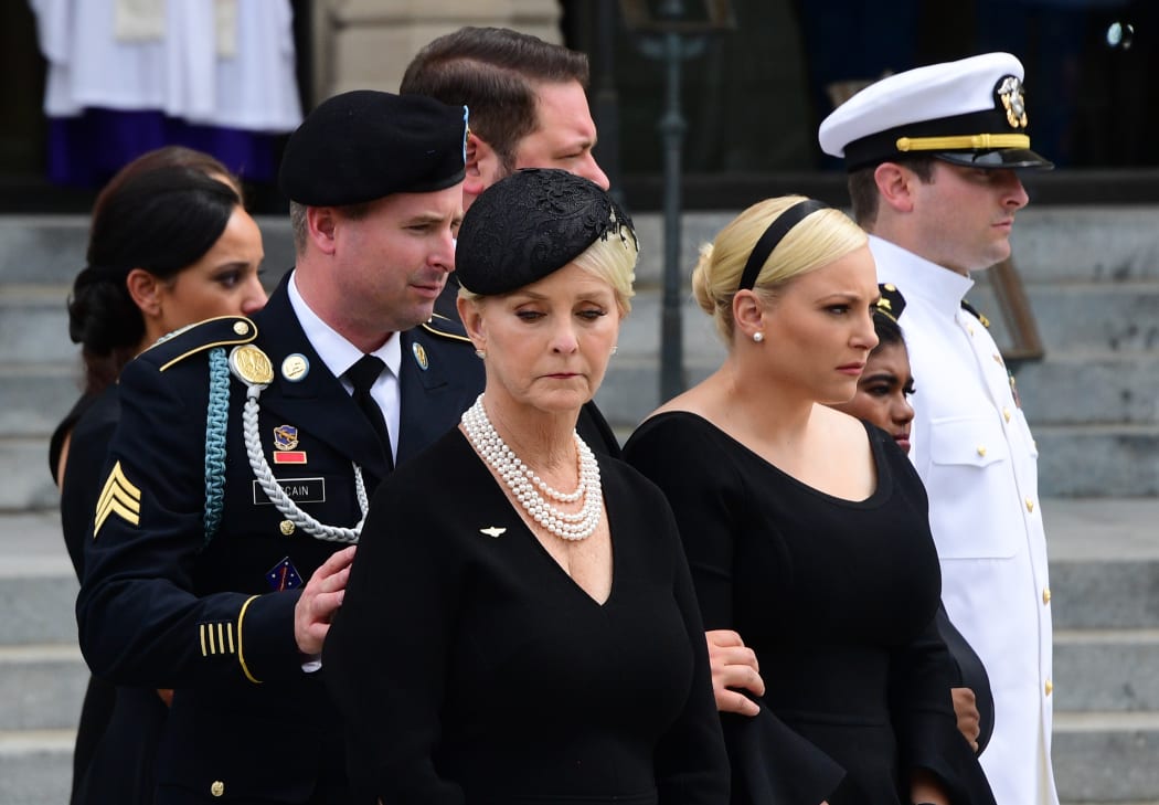 (L-R) James McCain, Cindy McCain, Meghan McCain, Bridget McCain, John Sydney McCain watch as a Military Honor Guard carries the casket of US Senator John McCain at the end of his memorial service for  at the Washington National Cathedral in Washington, DC.