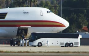 Some 200 US citizens evacuated from Wuhan were met on the tarmac by emergency vehicles and three buses at Riverside, California on January 29, 2020.