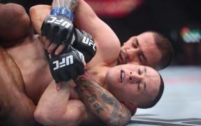 Alexandre Pantoja of Brazil submits Kai Kara-France of New Zealand in their flyweight co-main event title bout during UFC 317.