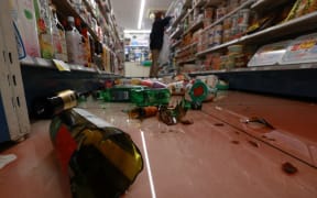 Wine and sake bottles are scattered  by a massive earthquake at a covenient store in Ishinomaki, Miyagi Prefecture on Feb. 13, 2021.