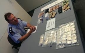 Detective Inspector Darrin Thompson with the methamphetamine and cash