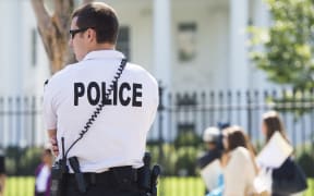 A member of the US Secret Service Uniformed Division patrols outside the White House.