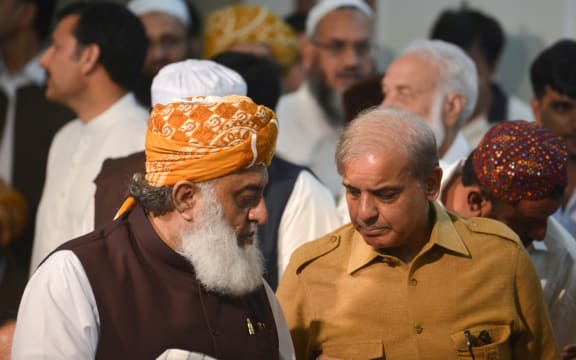 Shahbaz Sharif (R), the younger brother of ousted Pakistani prime minister Nawaz Sharif and head of Pakistan Muslim League-Nawaz (PML-N), arrives with   opposition leader Maulana Fazalur Rehman (L) for a press conference.