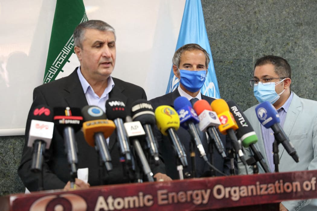 Head of the AEOI Mohammad Eslami delivers a speech next to director general of the International Atomic Energy Agency (IAEA) Rafael Grossi.
