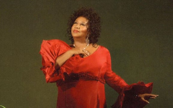 Cover image of Aretha Franklin's album 'This Christmas'. Aretha in a red gown.