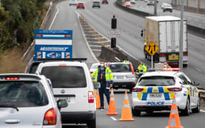 Police check motorists going on motorway in Auckland the day before the Easter long weekend begins.