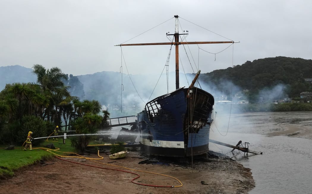 Firefighters dampen down the remains of the Tui on Wednesday morning.