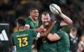 RG Snyman celebrates a try with Damian Williamse and Canan Moodie.