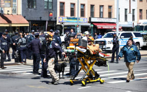 New York City Police Department members investigate the crime scene after multiple people were shot and undetonated devices were found at a subway station in New York City.