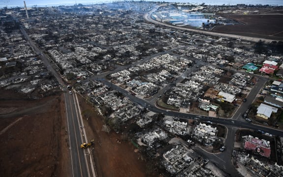 An aerial image taken on August 10, 2023 shows destroyed homes and buildings burned to the ground in Lahaina in the aftermath of wildfires in western Maui, Hawaii. At least 36 people have died after a fast-moving wildfire turned Lahaina to ashes, officials said August 9, 2023 as visitors asked to leave the island of Maui found themselves stranded at the airport. The fires began burning early August 8, scorching thousands of acres and putting homes, businesses and 35,000 lives at risk on Maui, the Hawaii Emergency Management Agency said in a statement. (Photo by Patrick T. Fallon / AFP)