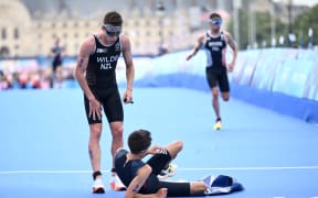 Hayden Wilde of New Zealand reacts with winner Alex Yee of Great Britain during the men’s individual triathlon in Paris.