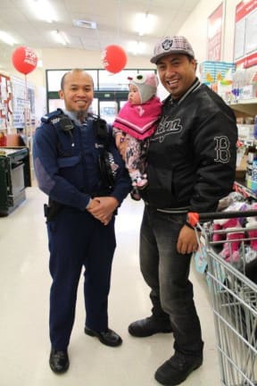 Local bouncer Toate and his daughter with Constable Abu in the supermarket.jpg