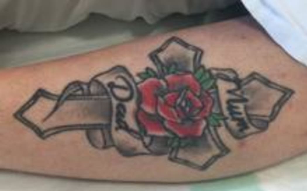 Police are trying to identify a woman with this tattoo, after she was found with serious head injuries north of Auckland.