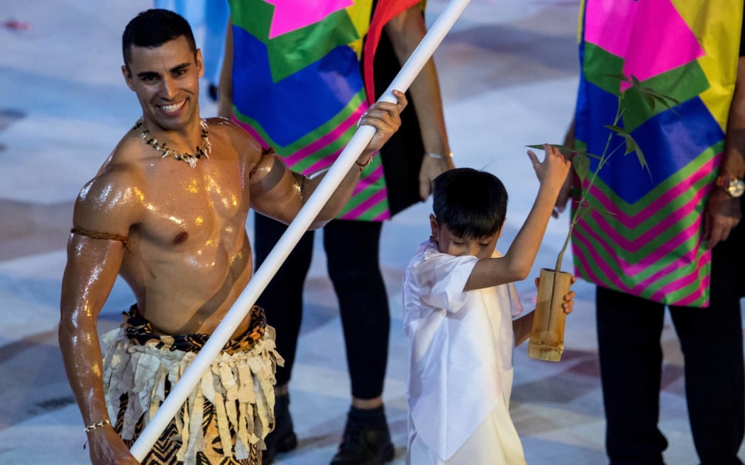 Pita Taufatofua leads the Tonga team into the stadium in Rio de Janiero.