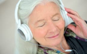 elderly woman with headphones