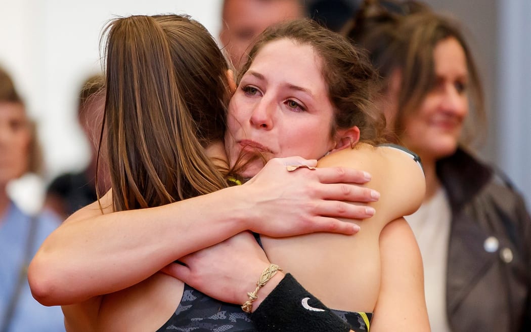 Olivia McTaggart, left, hugs Eliza McCartney after both failed to clear 4.50m during a pole vault Olympic qualifying competition at AUT Millennium, Auckland on Saturday, June 19, 2021.