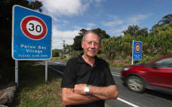 Parua Bay village’s 30km/h speed zone needs additional speed bridges to property slow vehicles still travelling too quickly past local Pārua Bay School (back left distance) says resident Colin Edwards.