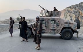 Taliban security personnel stand guard near the Torkham border crossing between Afghanistan and Pakistan in the Nangarhar province on February 27, 2026. Pakistan bombed major cities in Afghanistan including the capital Kabul on February 27, with Islamabad's defence minister declaring the neighbours at "open war" following months of tit-for-tat clashes. AFP journalists in Kabul and Kandahar heard blasts and jets overhead, as Pakistan launched air strikes on the Afghan capital and southern power base of the Taliban authorities. (Photo by Aimal Zahir / AFP)