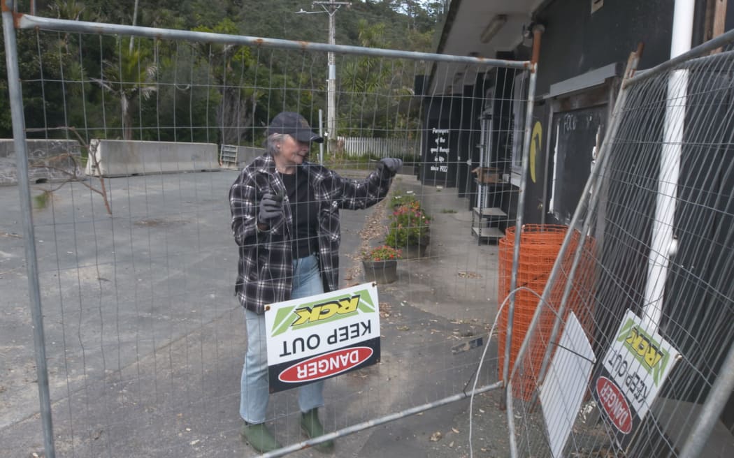 Clare Bradley begins the big clean-up job at the Muriwai Lodge.
