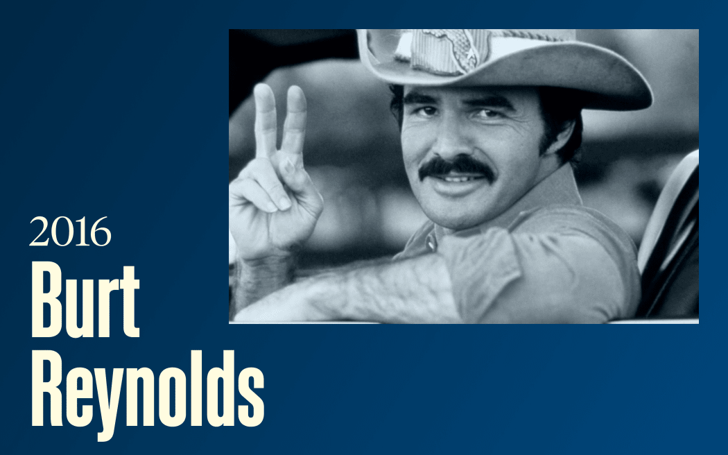 A moustachioed man in a cowboy hat giver the "peace" sign (Burt Reynolds as "The Bandit", , text reads "2016, Burt Reynolds"