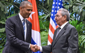 US President Barack Obama, left, and Cuban President Raul Castro shake hands during a meeting at the Revolution Palace in Havana on 21 March 21, 2016.