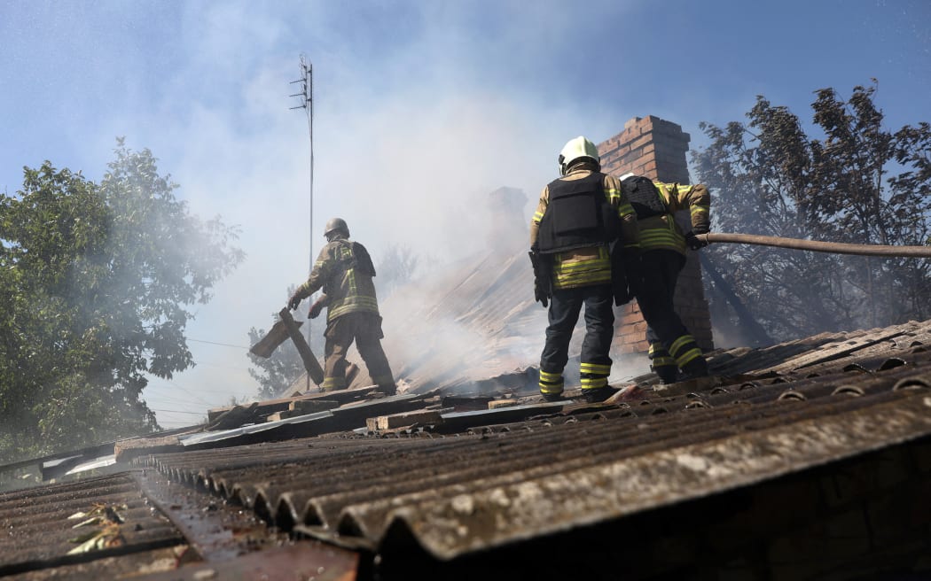 Ukrainian firefighters put out a fire in a destroyed house following Russian shelling in the town of Bakhmut, Donetsk region on 24 August 2022.