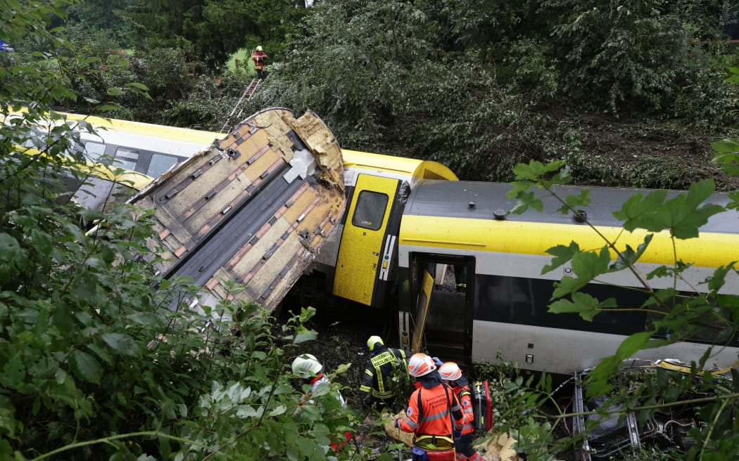 Rescue forces work at the site of a derailed train near Riedlingen near Biberach on July 27, 2025. (Photo by Thomas Warnack / dpa / AFP) / Germany OUT / GERMANY OUT / GERMANY OUT