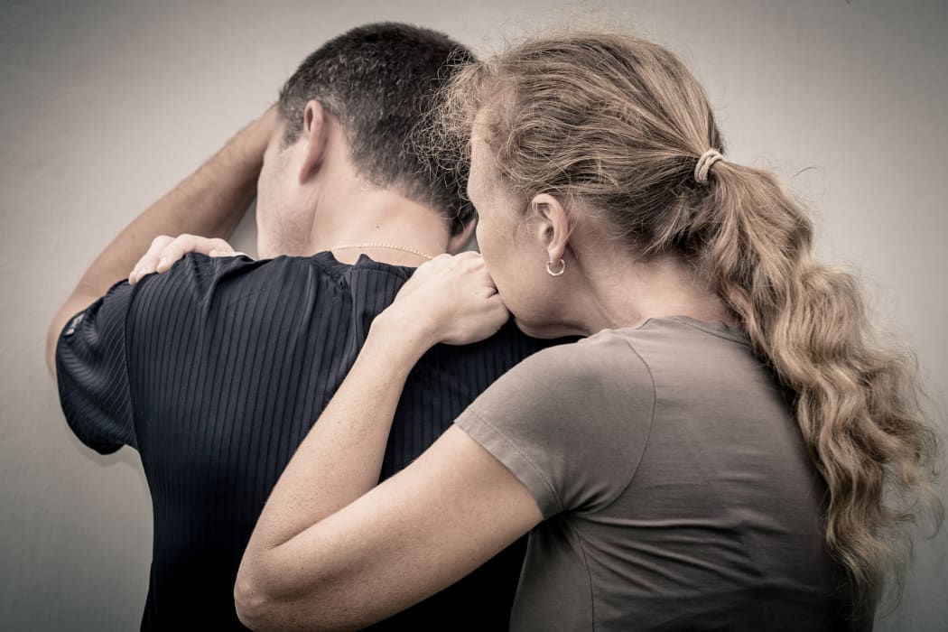 Sad woman hugging her husband