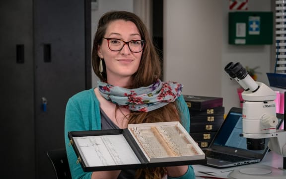 Dr Eimear Egan with boxes of fish ear bones collected in the 197os that she has been using to analyse past climate.