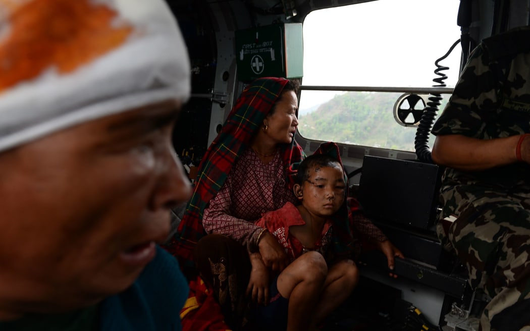 Nepalese villagers injured in the earthquake being evacuated from Lapu.