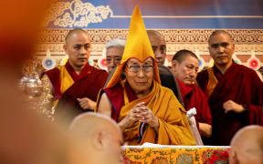 Tibetan spiritual leader the Dalai Lama (C) attends a Long Life Prayer offering ceremony at the Main Tibetan Temple in McLeod Ganj, near Dharamsala on June 30, 2025. Exiled Tibetan spiritual leader, the Dalai Lama, gave on June 30, the strongest indication yet that the 600-year-old institution would continue after his death, at prayer celebrations for his 90th birthday. The leader, who turns 90 on July 6, is according to Tibetans the 14th reincarnation of the Dalai Lama. (Photo by Sanjay BAID / AFP)