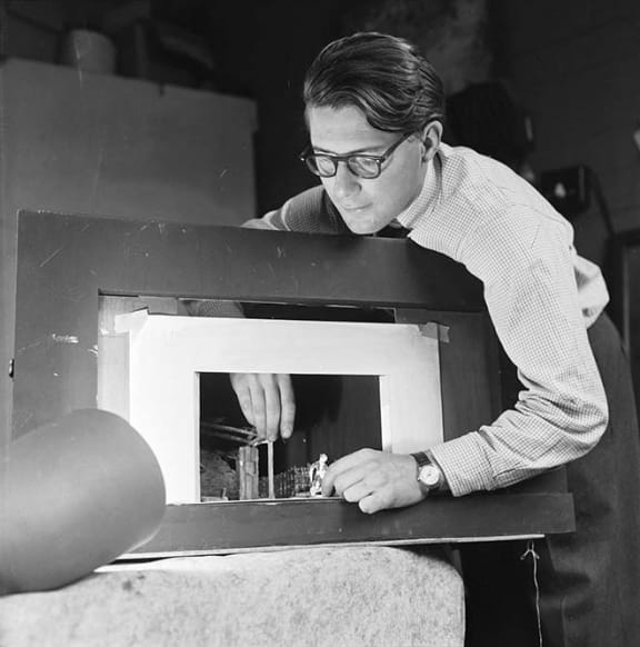 Raymond Boyce, set designer for the New Zealand Players, with a miniature model of a stage and set. Evening post (Newspaper. 1865-2002) :Photographic negatives and prints of the Evening Post newspaper.