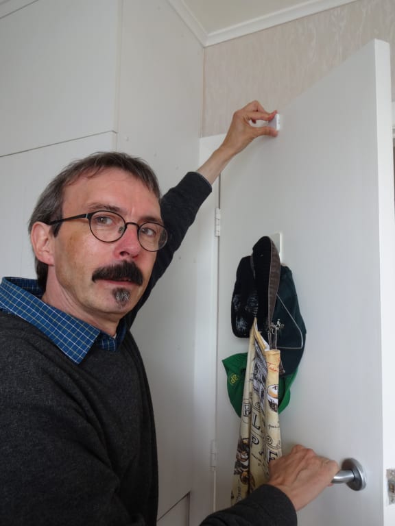 BRANZ physicist Manfred Plagmann instals a sensor on the bathroom door.