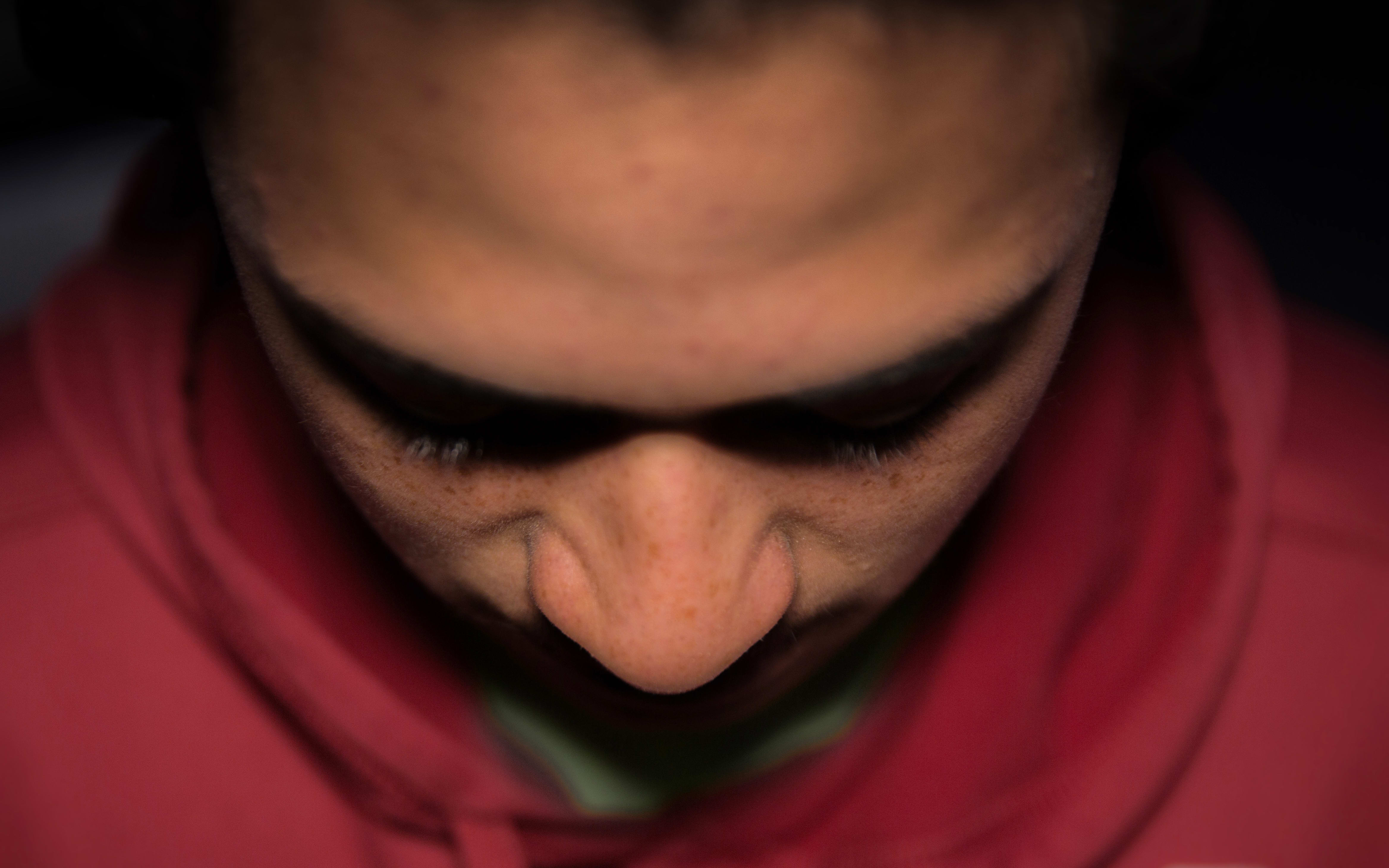 A teenage Māori boy looking unhappy