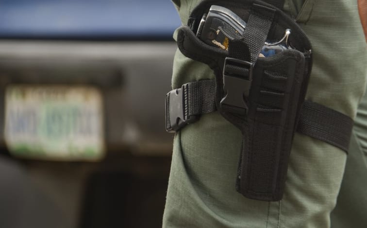 police officer on duty with Glock service revolver patrols during Stakeholders Engagement on Internal Security and Conflict Resolution across the country held in Lagos State